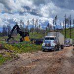 Machine working to load waste wood into a large truck